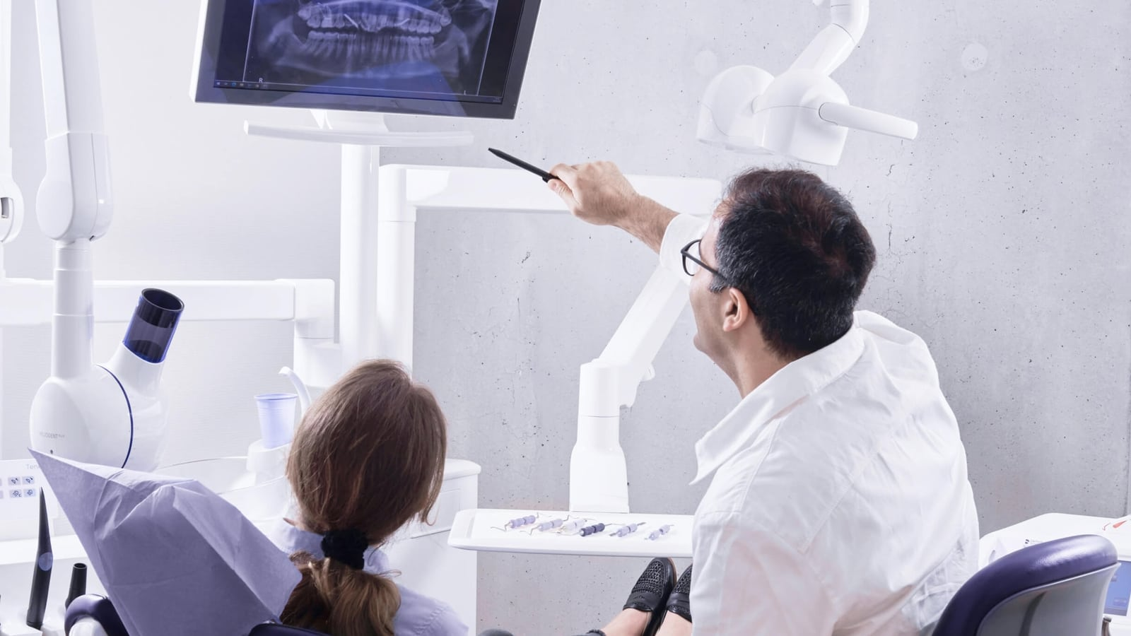 Dentist explaining bridge and restoration options